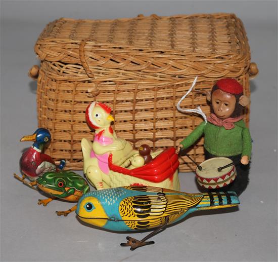 A Schuco tinplate clockwork monkey drummer, similar frog (US-Zone Germany), bird and duck and a Hen & Chicks battery-operated toy